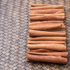 Cinnamon stick spice over wicker background
