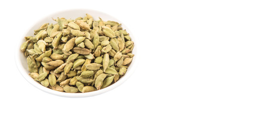 Cardamom spices in white bowl over white background