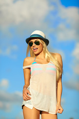 Portrait of a beautiful woman in glasses on the beach