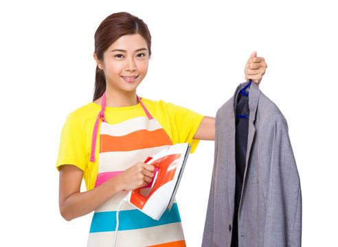 Housewife using the steam iron on suit jacket