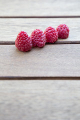 raspberries on wooden table