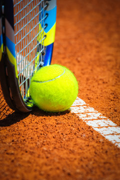 Tennis Ball and Racquet on the court