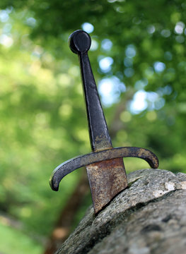 excalibur the famous sword in the stone of king Arthur in the fo