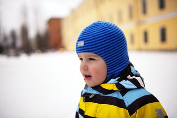 Portrait of small child in cap and overalls