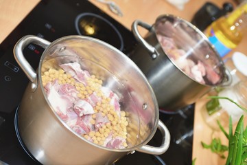 Pan with soup prepares on electric stove