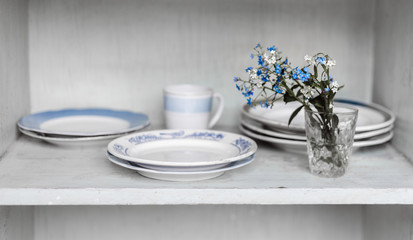 Dishes on wooden shelf