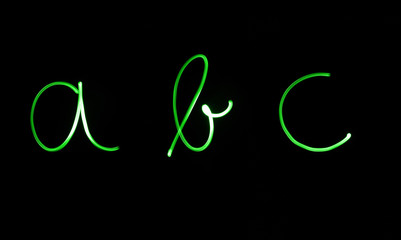 Flourescent letters 'abc' in bright green neon color