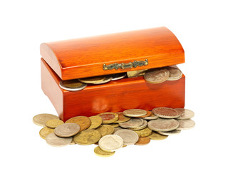 Old wooden chest is full of coins isolated on white background.