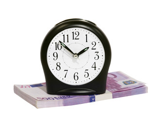 Time to gain money.Black clock on euro banknotes stack isolated on white background.