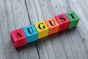 word august on colorful wooden cubes - obrazy, fototapety, plakaty