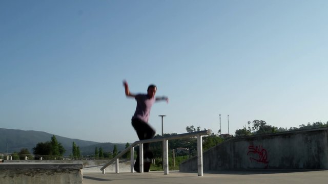 Skateboarder breaks its skateboard truck performing a grind trick on a skatepark.
