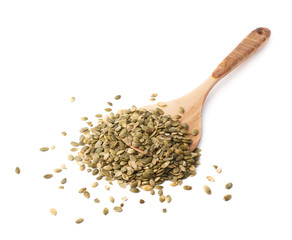 Wooden spoon covered with pumpkin seeds
