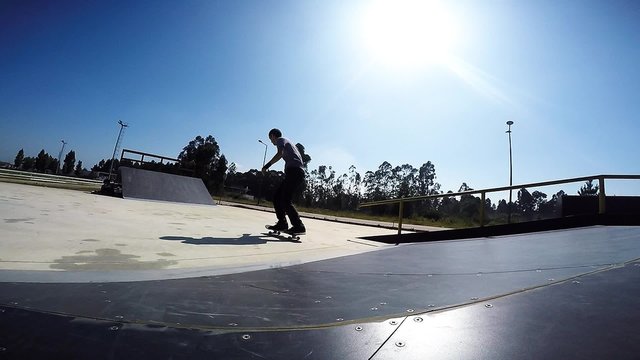 Slow Motion shot of skateboarder performing an ollie grab In skateboard park