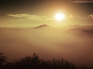 Fototapeta na wymiar Magnificent heavy mist in landscape. Autumn fogy sunrise in a countryside. Hill increased from fog.