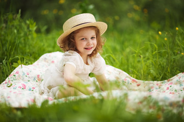 Little happy girl is sitting and resting