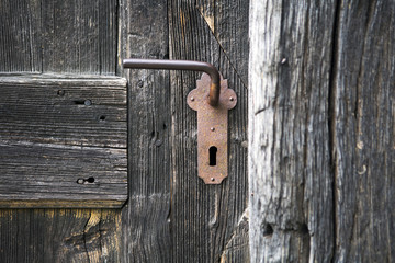 old wooden entrance door with antique door handle