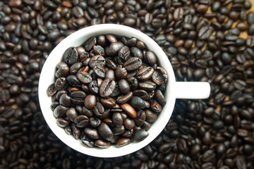 Cup full of coffee beans background vintage tone