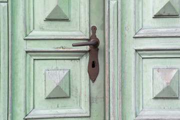 old wooden entrance door with antique door handle