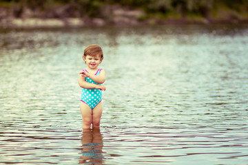 Little girl in a riwer water