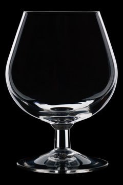 Perfect, clean, cognac glass against a black background