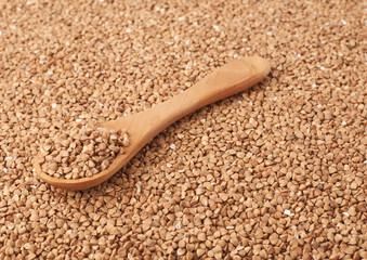 Wooden spoon over the buckwheat