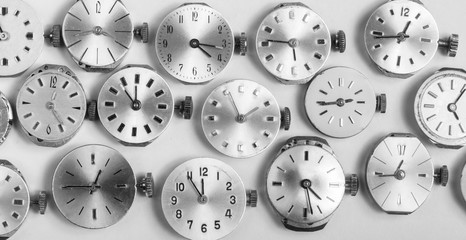 a bunch of pocket watch clockworks in black and white