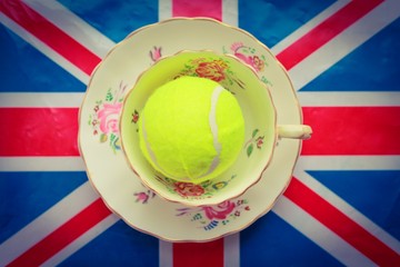 British Tennis - A cup and saucer with a tennis ball inside on top of a union jack flag