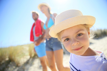 Family walking to the beach on a sunny day