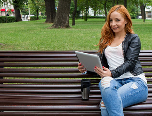 Pretty girl posing with a tablet in cafe