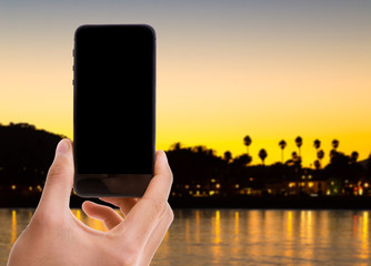 Phone with black screen with American Sunset on background