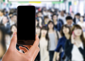 Phone with black screen with a crowd of people in Asia