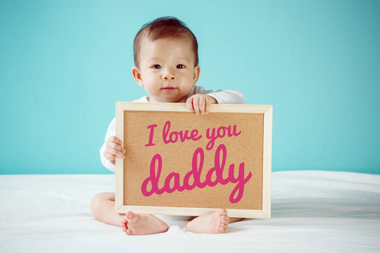 Baby writing "I Love you Daddy" on the board, new family concept