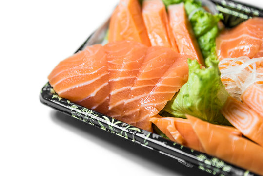 Slices of raw salmon shashimi closeup focused on the salmon slic