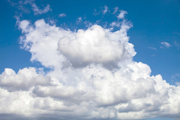Naklejka na ściany i meble Puffy Cloud Against A Deep Blue Sky