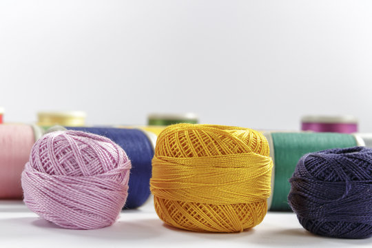 Skeins of cotton thread pink, orange and dark-blue