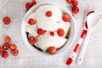 Vanilla ice cream with fresh wild strawberries. Top view.