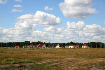 Fototapeta na wymiar The new village / New buildings in the depths of Siberia. Landscape with new houses forming a small village.
