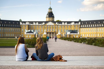 Karlsruhe Schloss, young women in foreground - obrazy, fototapety, plakaty