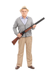 Serious senior gentleman holding a shotgun