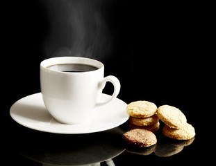 Cup of coffee with cookies and saucer on black