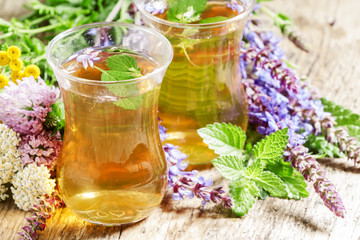 Green hot tea with herbs in Islamic glasses, selective focus