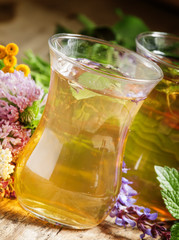Green hot tea with herbs in Islamic glasses, selective focus