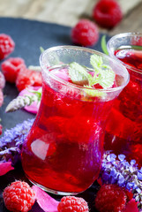 Hot red tea with raspberries, mint and rose petals, selective fo