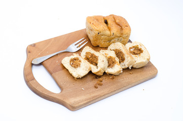 dried shredded pork bread on cutting board on a white background