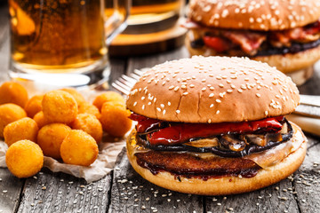 Delicious burger with fried potato balls and beer