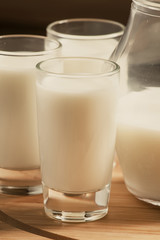 Fresh peasant milk jug and glasses on  wooden table, selective f