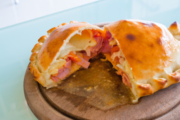 Pizza puff on the wood plate