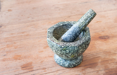 Thai style stone mortar on wood table