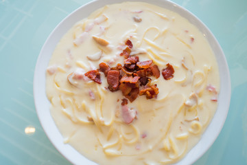 spaghetti extreme cheese carbonara sauce on glass background