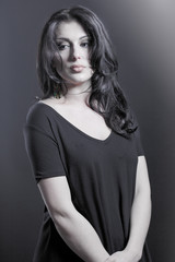 Portrait of a beautiful young brunette. Beautiful woman with shiny hair. Impressive woman